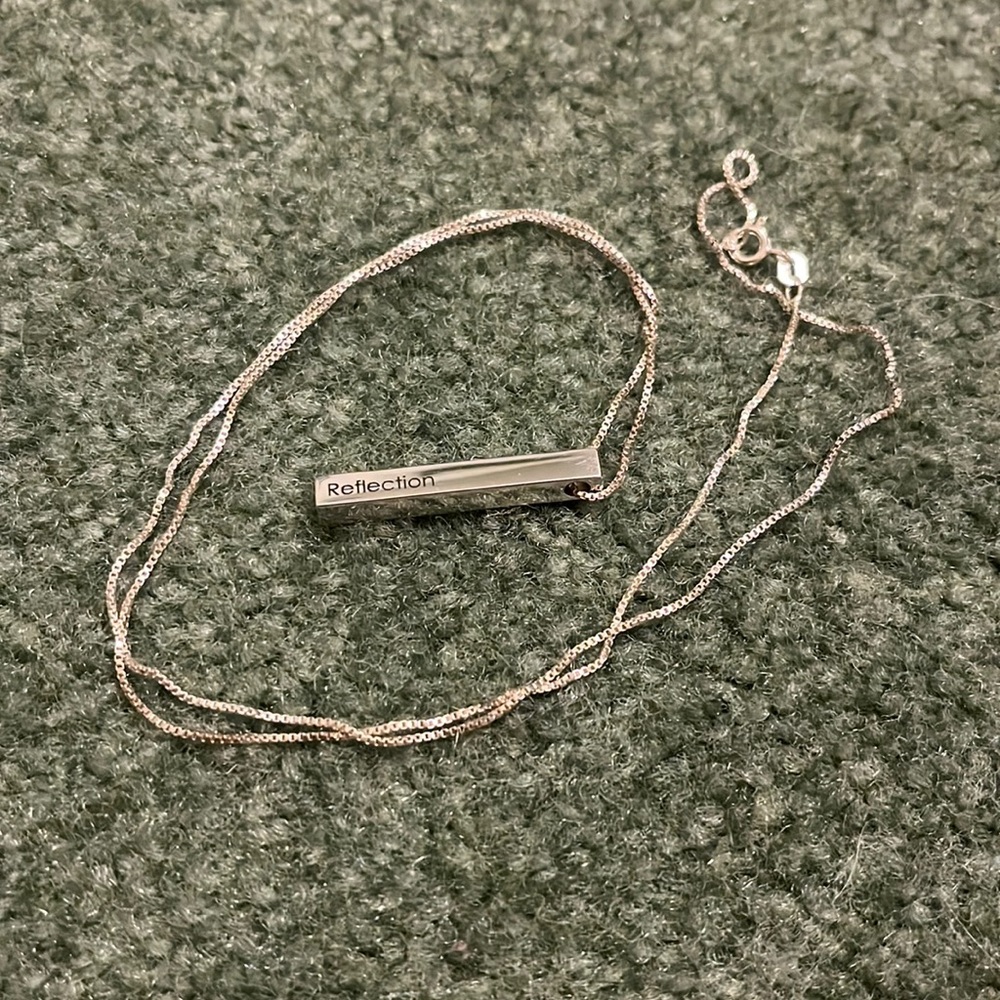 Silver bar necklace says Reflection